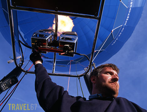 Hot air balloon pilot David Fish fires the burner