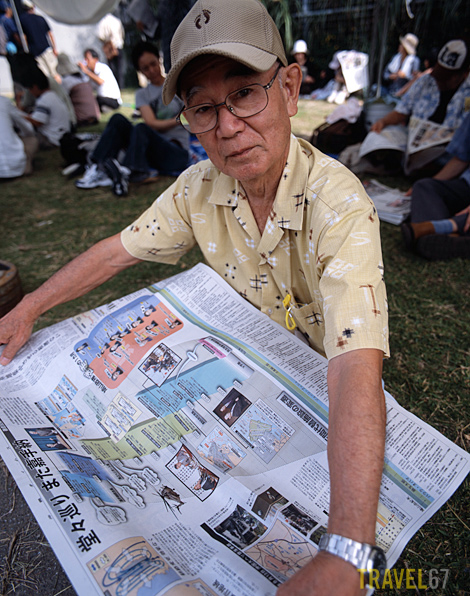 Okinawan man reads newspaper outlining the Futenma situation. Okinawa 8 Nov 2009
