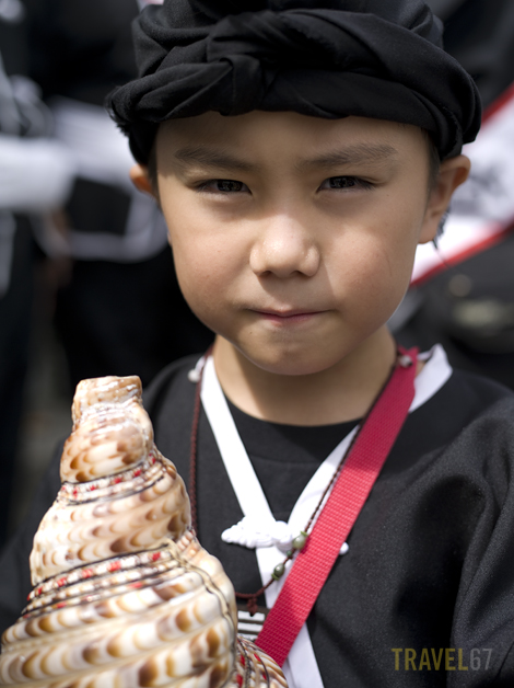Okinawan boy with conch shell horn