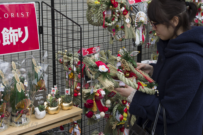 Japanese woman shopping for a New Years wreath, Tokyo, Japan