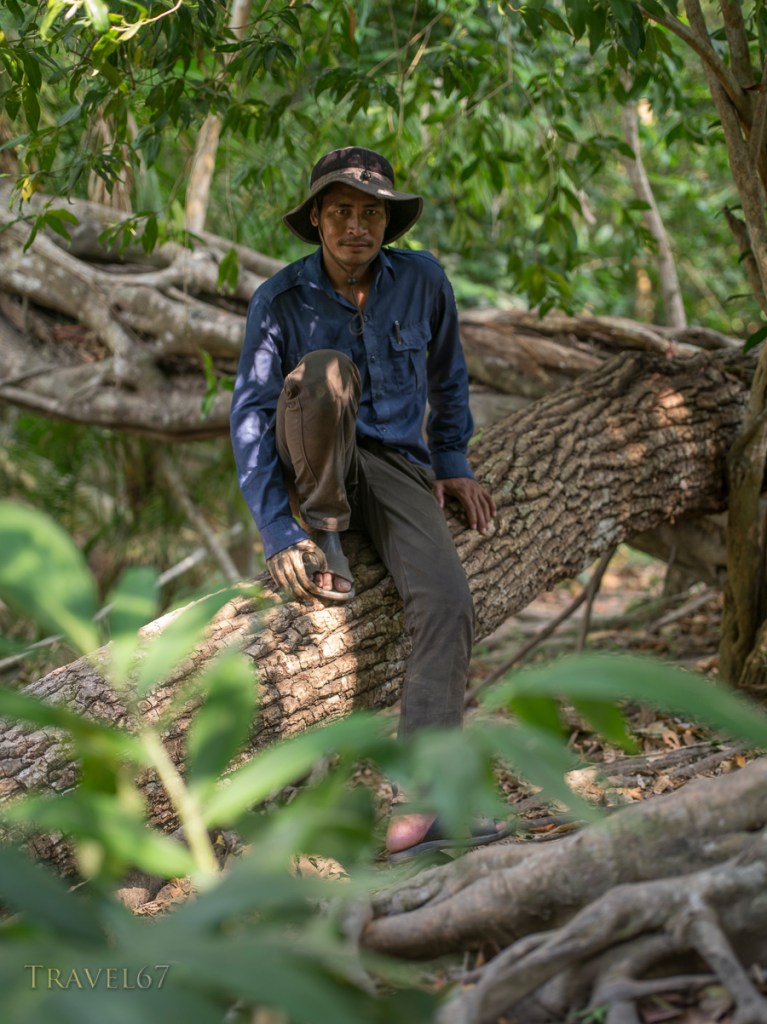 Guide with landmine injury resulting in loss of hand. Kbal Spean carvings in the riverbed northeast of Angkor. Siem Reap, Cambodia