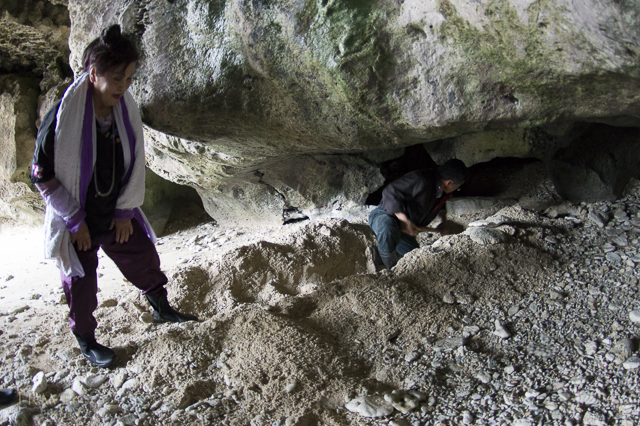 Yuta (priestess) Ayako Toguchi conducts prayers at sea cave called Sururu Gama on the coast of Kouri Island, Okinawa, Japan