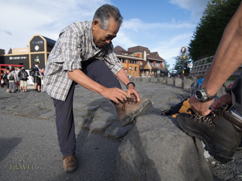 Japanese climber laces up boots at Fuji Subaru Line 5th Station