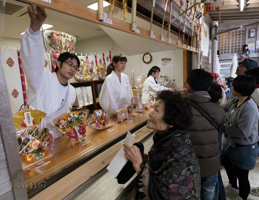 New Year Celebrations at Futenma Shrine, Okinawa, Japan. 1/1/2015. Purchasing omamori charms for the year.