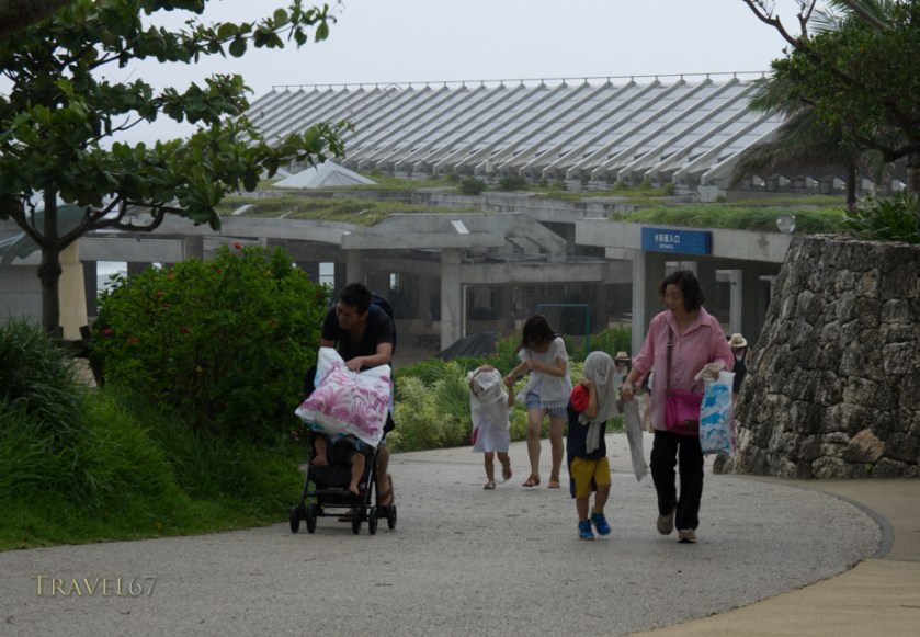 Visitors to the Churaumi Aquarium hit by downpour. Typhoon Chan-hom brings strong wind and rain to the islands of Okinawa, Japan 9 July 2015
